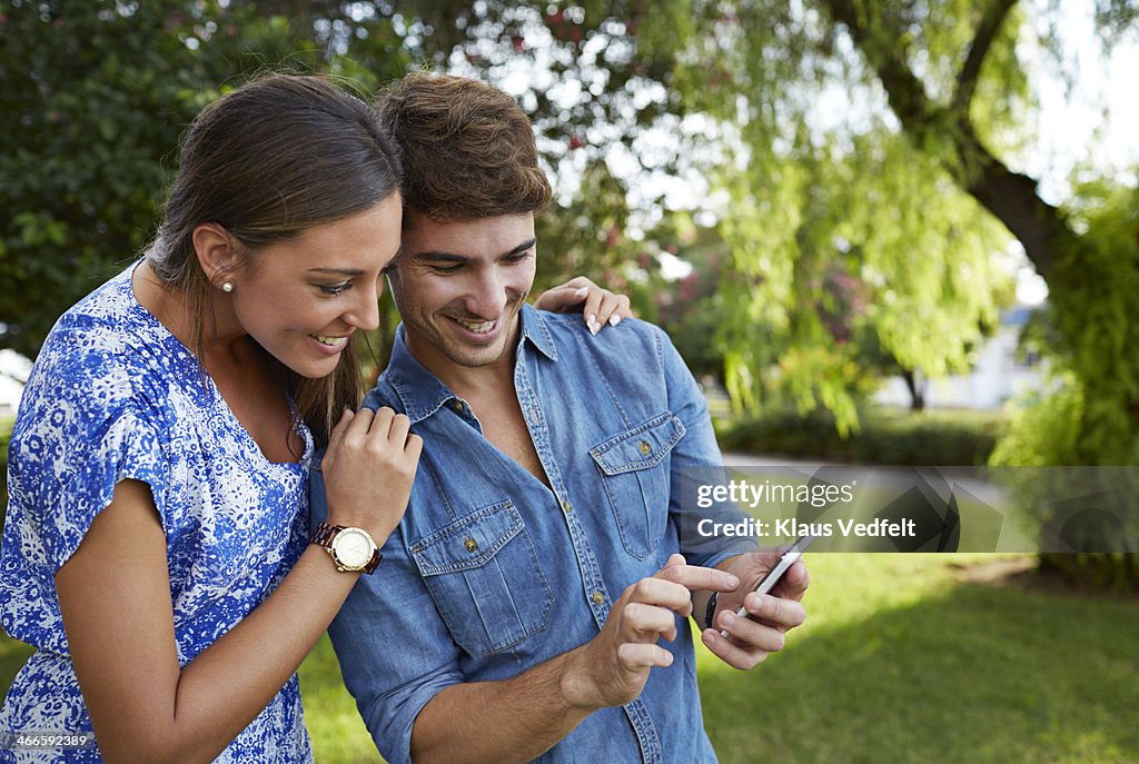 Couple looking at photos on phone