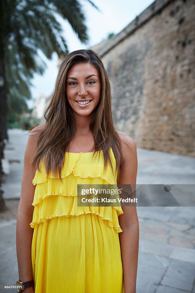 Portrait of cute young woman i yellow dress