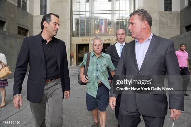 Millionaire Robert Durst leaves Manhattan Criminal Court with his lawyers on Friday, August 16, 2013. Durst had been arrested for trespassing after...
