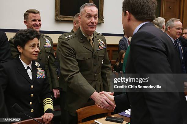 Vice Chief of Naval Operations Adm. Michelle Howard and Commandant of the Marine Corps Gen. Joseph Dunford greet members of the House Armed Services...