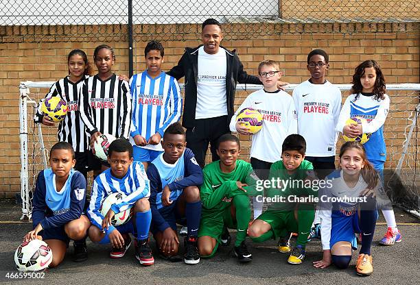 Nathaniel Clyne poses for a photograph with the school children during the Premier League Players Kit Scheme Launch at Allen Edward Primary School on...