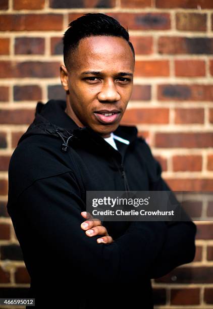 Nathaniel Clyne poses for a photo during the Premier League Players Kit Scheme Launch at Allen Edward Primary School on March 17, 2015 in London,...