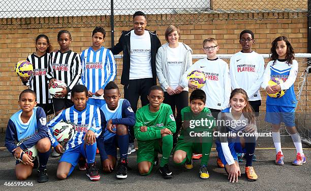 Nathaniel Clyne and Fran Kirby pose for a photograph with the school children during the Premier League Players Kit Scheme Launch at Allen Edward...