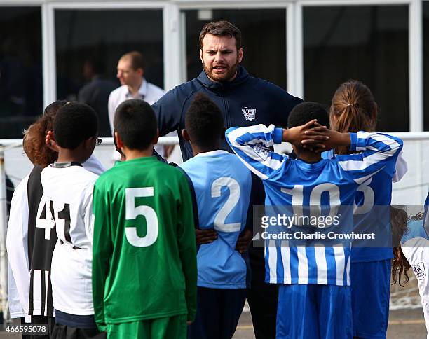 The school children take part in activities during the Premier League Players Kit Scheme Launch at Allen Edward Primary School on March 17, 2015 in...