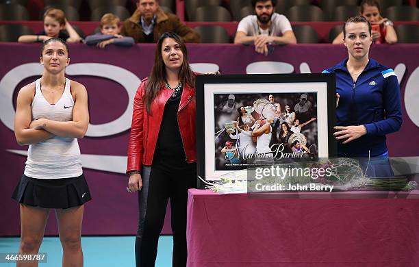 Sara Errani of Italy and Anastasia Pavlyuchenkova of Russia attend the tribute to Marion Bartoli of France, who retired last year from tennis, during...