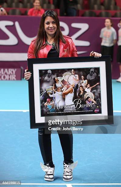 Marion Bartoli of France, who retired last year from tennis, reacts during a tribute to her at the 22nd Open GDF Suez held at the Stade de Coubertin...