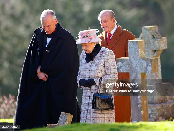 Reverend Jonathan Riviere, Queen Elizabeth II and Prince Philip, Duke of Edinburgh leave the church of St Peter and St Paul in West Newton, after...