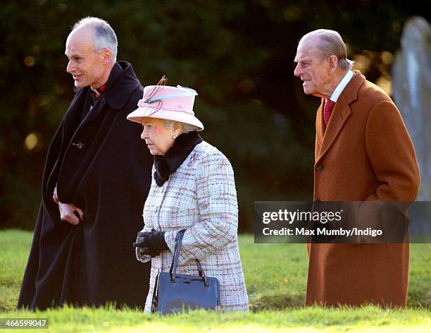 Reverend Jonathan Riviere, Queen Elizabeth II and Prince Philip, Duke of Edinburgh leave the church of St Peter and St Paul in West Newton, after...