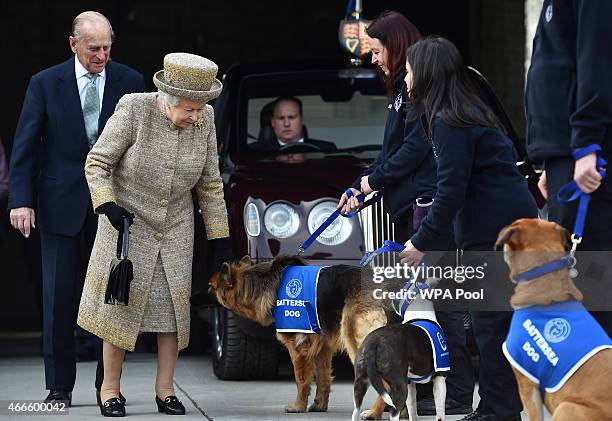 Britain's Queen Elizabeth II accompanied by Prince Philip, Duke of Edinburgh attend the opening of the new Mary Tealby dog kennels at Battersea Dogs...