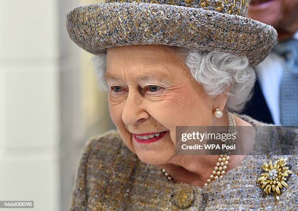 Britain's Queen Elizabeth II visits a kennel block during the opening of the new Mary Tealby dog kennels at Battersea Dogs and Cats Home in London on...