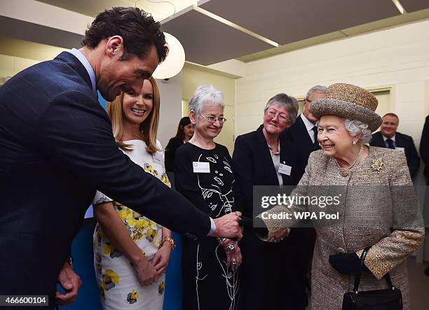 Britain's Queen Elizabeth II meets British model and patron David Gandy as she attends the opening of the new Mary Tealby dog kennels at Battersea...