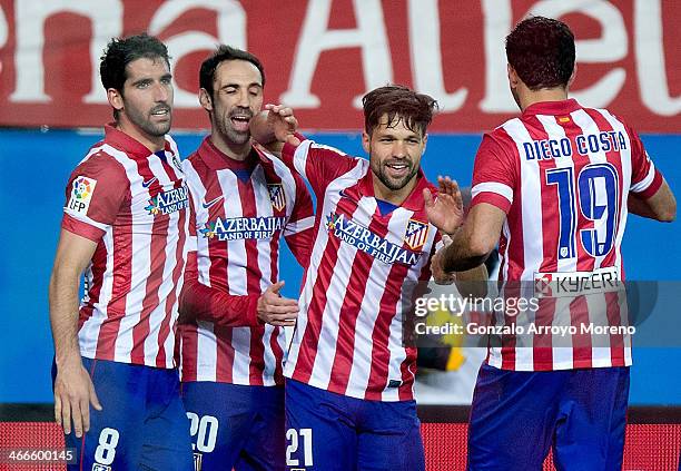 Diego Ribas celebrates scoring their fourth goal with teammates Diego Costa , Juan Francisco Torres alias Juanfran and Raul Garcia during the La Liga...