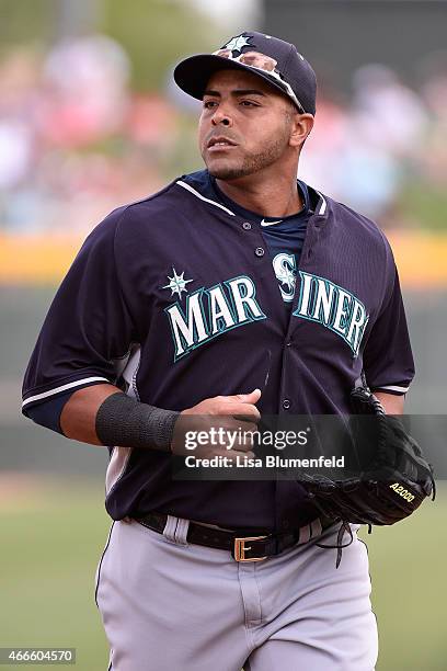 Nelson Cruz of the Seattle Mariners runs off the field during the game against the Oakland Athletics at HoHoKam Stadium on March 12, 2015 in Mesa,...