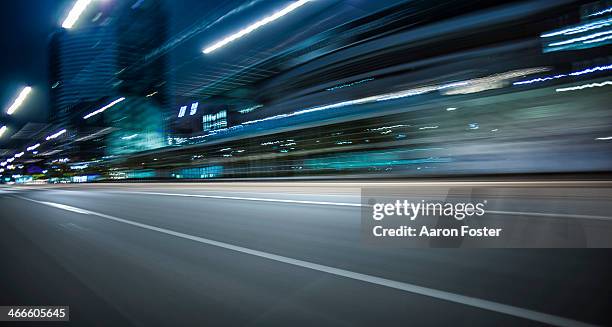 inner city street at night - city motion stock pictures, royalty-free photos & images