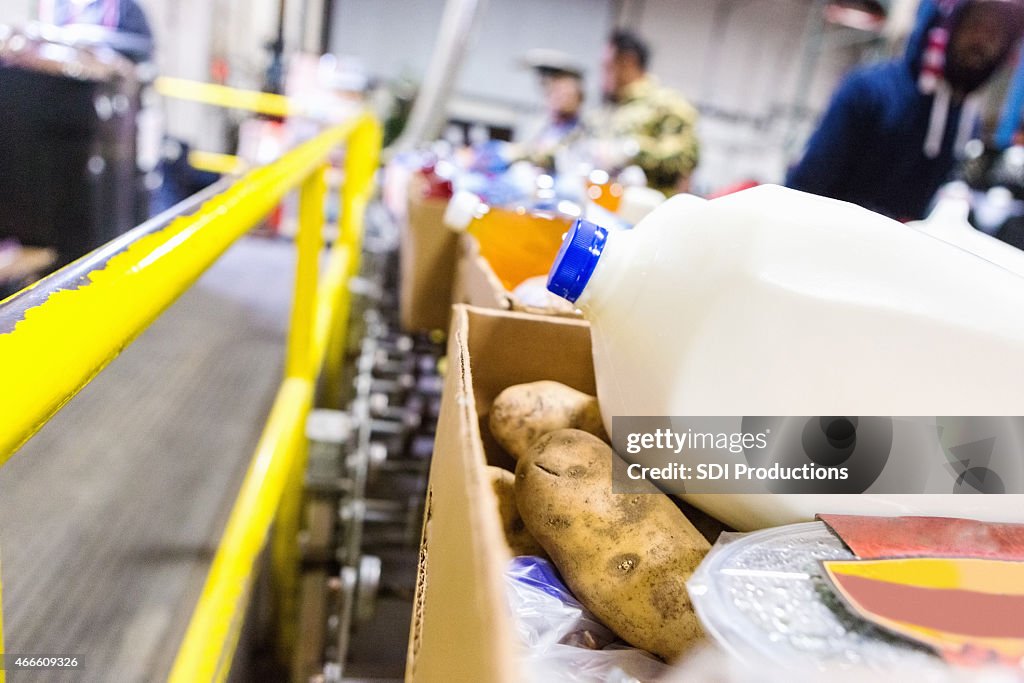 Healthy donated groceries in boxes at food bank warehouse
