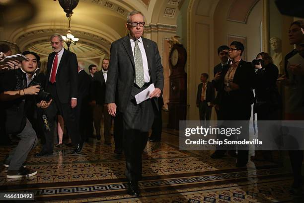 Senate Minority Leader Harry Reid approaches the microphone for a news conference following the Senate Democratic policy luncheon at the U.S. Capitol...