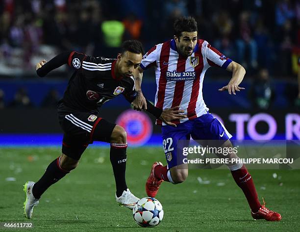 Leverkusen's forward Karim Bellarabi vies with Atletico Madrid's midfielder Cani during the UEFA Champions League football match Club Atletico de...