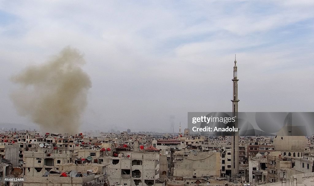 Syrian regime forces attack with barrel bombs on residential areas in Damascus