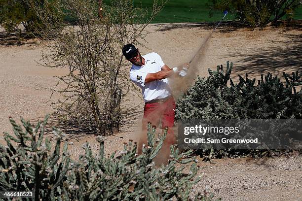 Graham DeLaet plays a shot on the 8th hole during the final round of the Waste Management Phoenix Open at TPC Scottsdale on February 2, 2014 in...