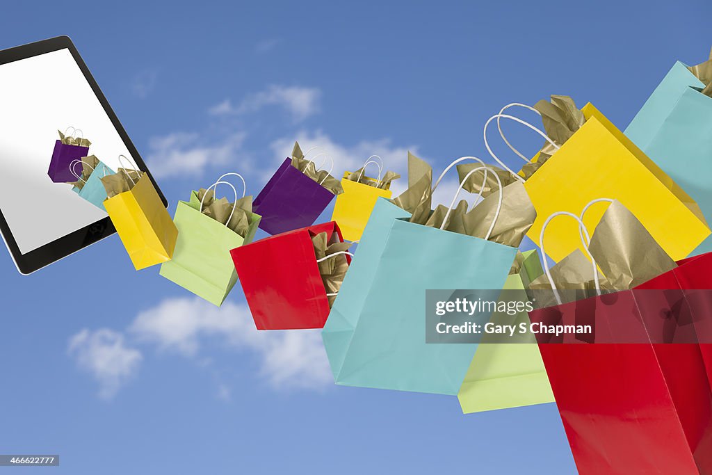 Colored shopping bags coming out of tablet
