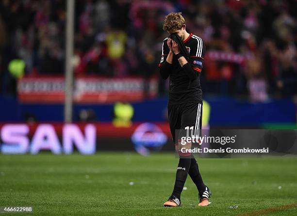 Dejected Stephan Kiessling of Bayer Leverkusen holds his head after missing a penalty in the shoot out during the UEFA Champions League round of 16...