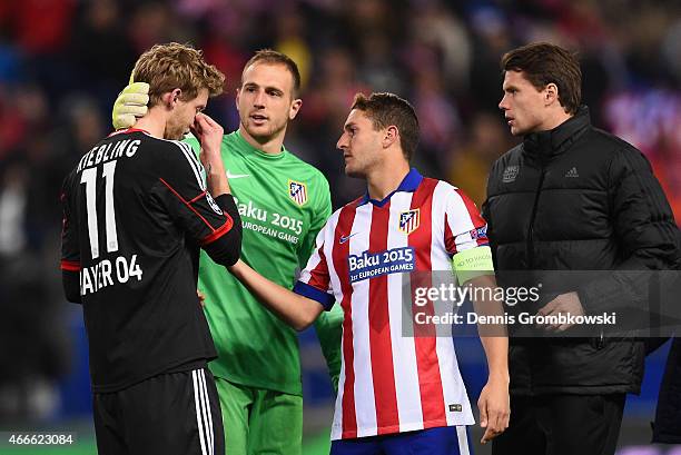 Stephan Kiessling of Bayer Leverkusen is consoled by goalkeeper Jan Oblak and Koke of Atletico Madrid after missing the last penalty in the shoot out...