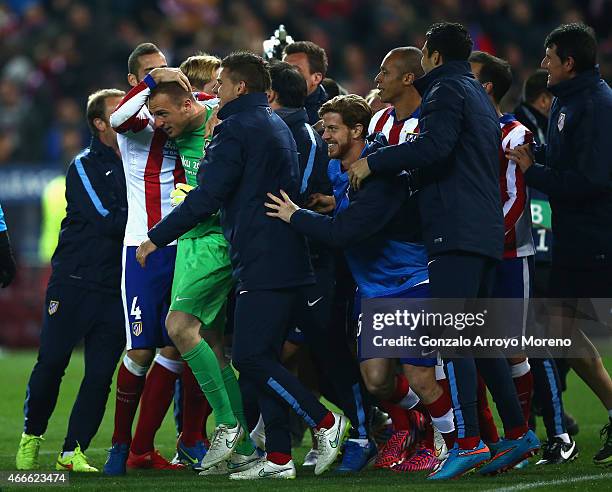 Jan Oblak of Atletico Madrid is mobbed by team mates after the penalty shoot out during the UEFA Champions League round of 16 match between Club...