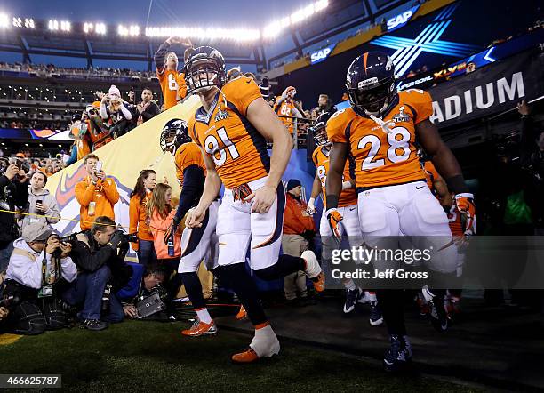 Tight end Joel Dreessen, running back Montee Ball of the Denver Broncos and teammates take the field prior to the start of Super Bowl XLVIII against...