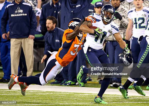 Wide receiver Percy Harvin of the Seattle Seahawks runs the ball against strong safety Duke Ihenacho of the Denver Broncos in the first quarter...