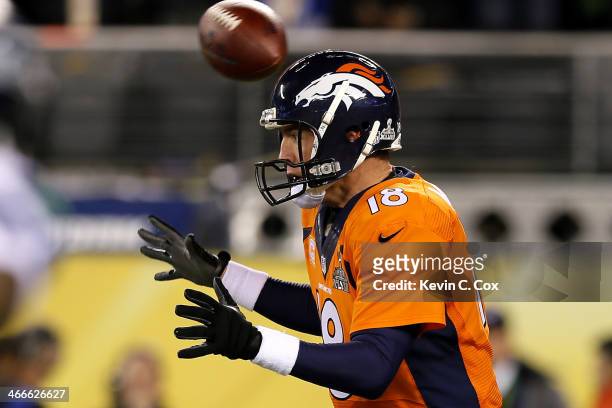 The ball flies over the head of quarterback Peyton Manning of the Denver Broncos in the first quarter against the Seattle Seahawks during Super Bowl...