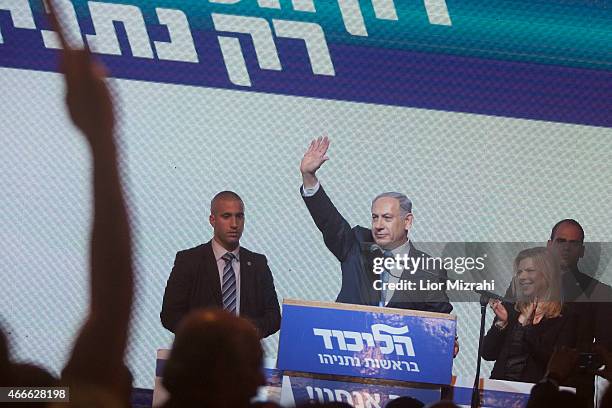 Israeli Prime Minister Benjamin Netanyahu waves to his supporters next to his wife Sara at his election campaign headquarters on March 17, 2015 in...