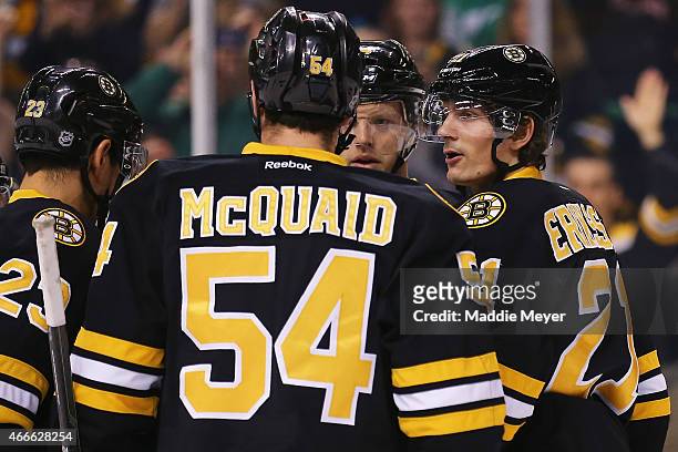 Adam McQuaid and Carl Soderberg congratulate Loui Eriksson of the Boston Bruins after he scored a goal against the Buffalo Sabres during the first...