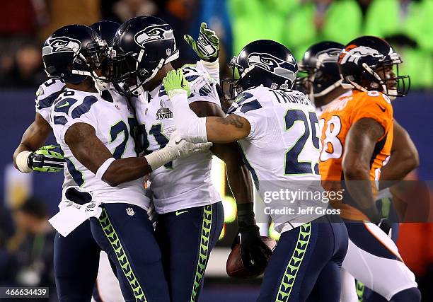 Strong safety Kam Chancellor of the Seattle Seahawks celebrates his interception with teammates against the Denver Broncos in the first quarter...