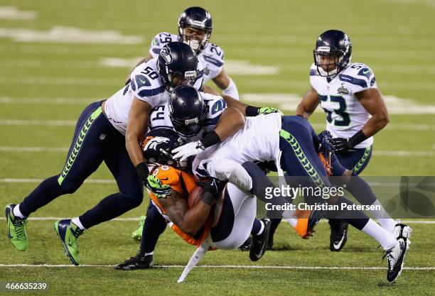 Wide receiver Demaryius Thomas of the Denver Broncos is tackled during Super Bowl XLVIII against the Seattle Seahawks at MetLife Stadium on February...