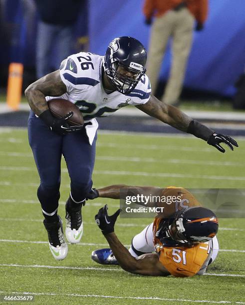 Michael Robinson of the Seattle Seahawks eludes the tackle of Paris Lenon of the Denver Broncos during the first half of Super Bowl XLVIII at MetLife...