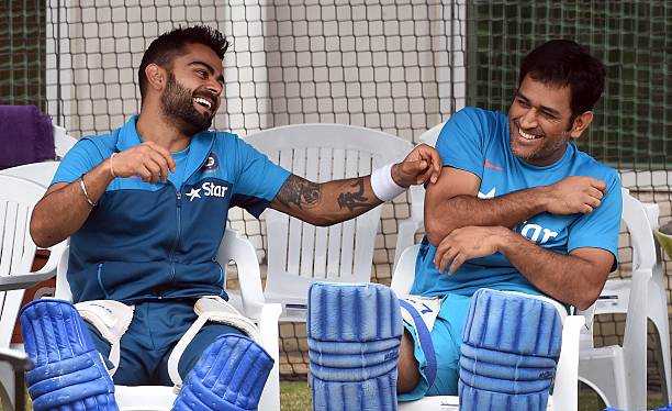 Indian cricket players Virat Kohli and captain Mahendra Singh Dhoni share a lighter moment during a training session ahead of their 2015 Cricket...