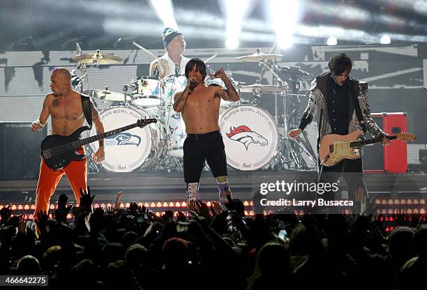 Flea, Chad Smith, Anthony Kiedis, and Josh Klinghoffer of the Red Hot Chili Peppers perform during the Pepsi Super Bowl XLVIII Halftime Show at...