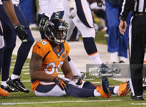 Wide receiver Demaryius Thomas of the Denver Broncos sits on the ground after fumbling the ball against the Seattle Seahawks in the third quarter...