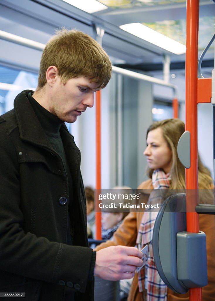 Young man validating ticket in a bus