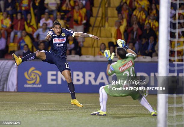 Mexican Club America's Michael Arroyo and Daniel Cambronero, goal keeper of Club Sport Herediano vie for the ball during the quarterfinals of the...