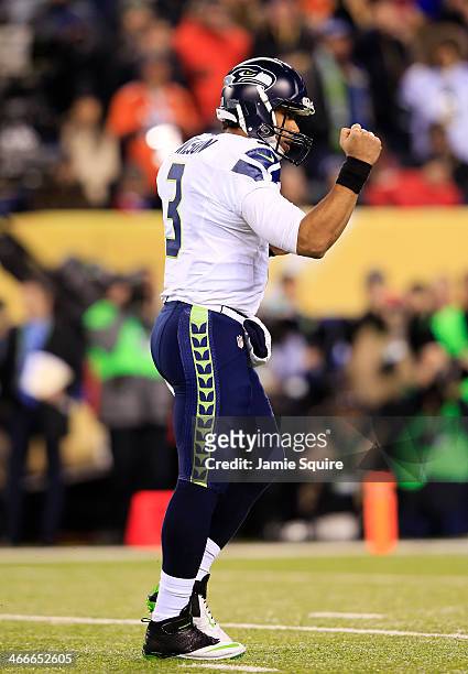 Quarterback Russell Wilson of the Seattle Seahawks celebrates a touchdown during the fourth quarter of Super Bowl XLVIII at MetLife Stadium on...