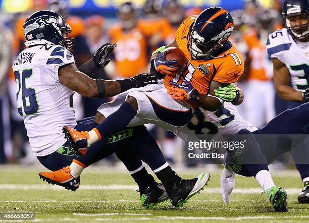 Wide receiver Trindon Holliday of the Denver Broncos is tackled during Super Bowl XLVIII at MetLife Stadium on February 2, 2014 in East Rutherford,...