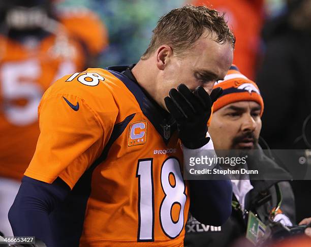 Quarterback Peyton Manning of the Denver Broncos walks off the field after their 43-8 loss to the Seattle Seahawks during Super Bowl XLVIII at...