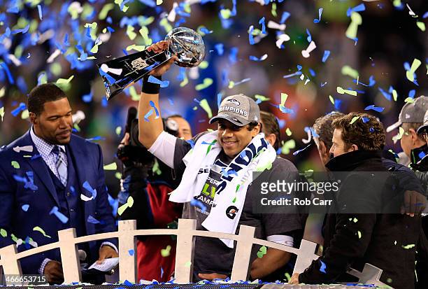 Russell Wilson of the Seattle Seahawks celebrates with the Vince Lombardi trophy after defeating the Denver Broncos 43-8 in Super Bowl XLVIII at...