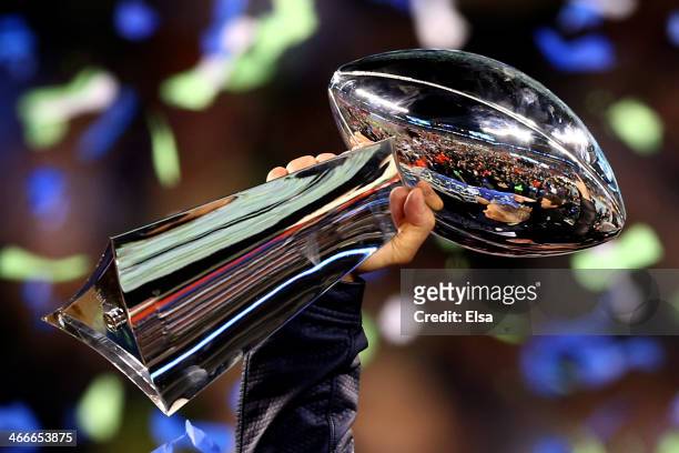 Head coach Pete Carroll of the Seattle Seahawks holds the Vince Lombardi Trophy after his team won Super Bowl XLVIII at MetLife Stadium on February...