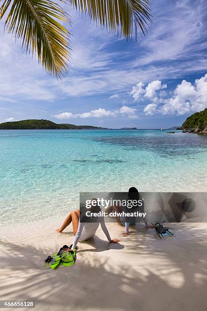 women sunbathing on a beach after snorkeling in st.john, usvi - caribbean sea stock pictures, royalty-free photos & images
