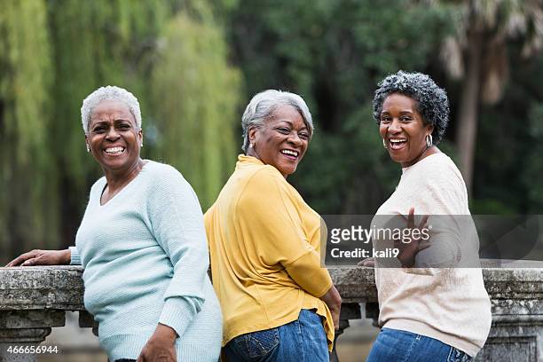 senior black women waving - black woman looking over shoulder stock pictures, royalty-free photos & images