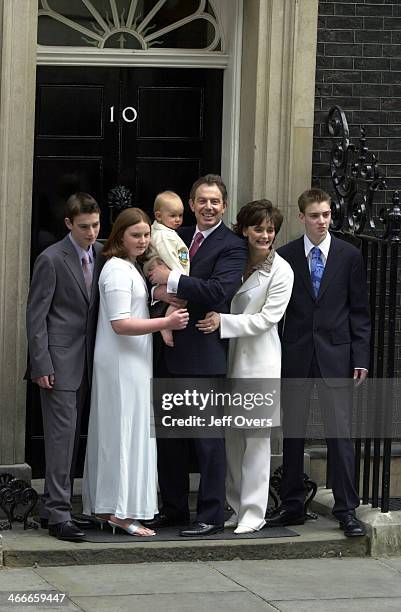 Prime Minister Tony Blair poses with his youngest son Leo, wife Cherie and children Nicholas, Kathryn and Euan on the steps of his official residence...