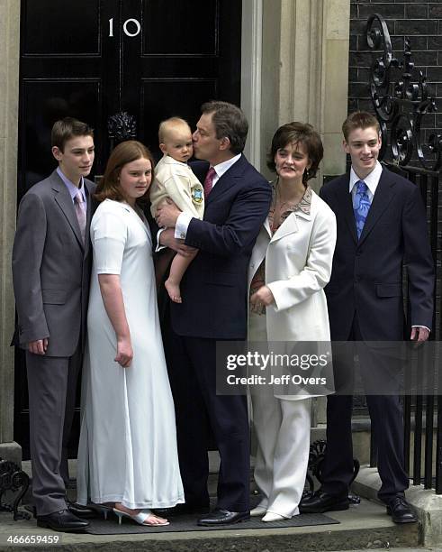 Prime Minister Tony Blair poses with his youngest son Leo, wife Cherie and children Nicholas, Kathryn and Euan on the steps of his official residence...