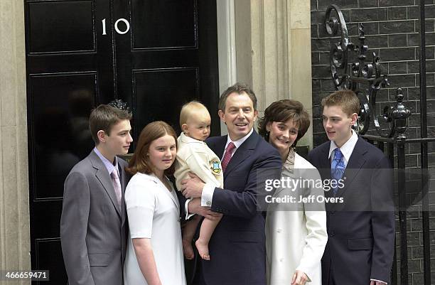 Prime Minister Tony Blair poses with his youngest son Leo, wife Cherie and children Nicholas, Kathryn and Euan on the steps of his official residence...